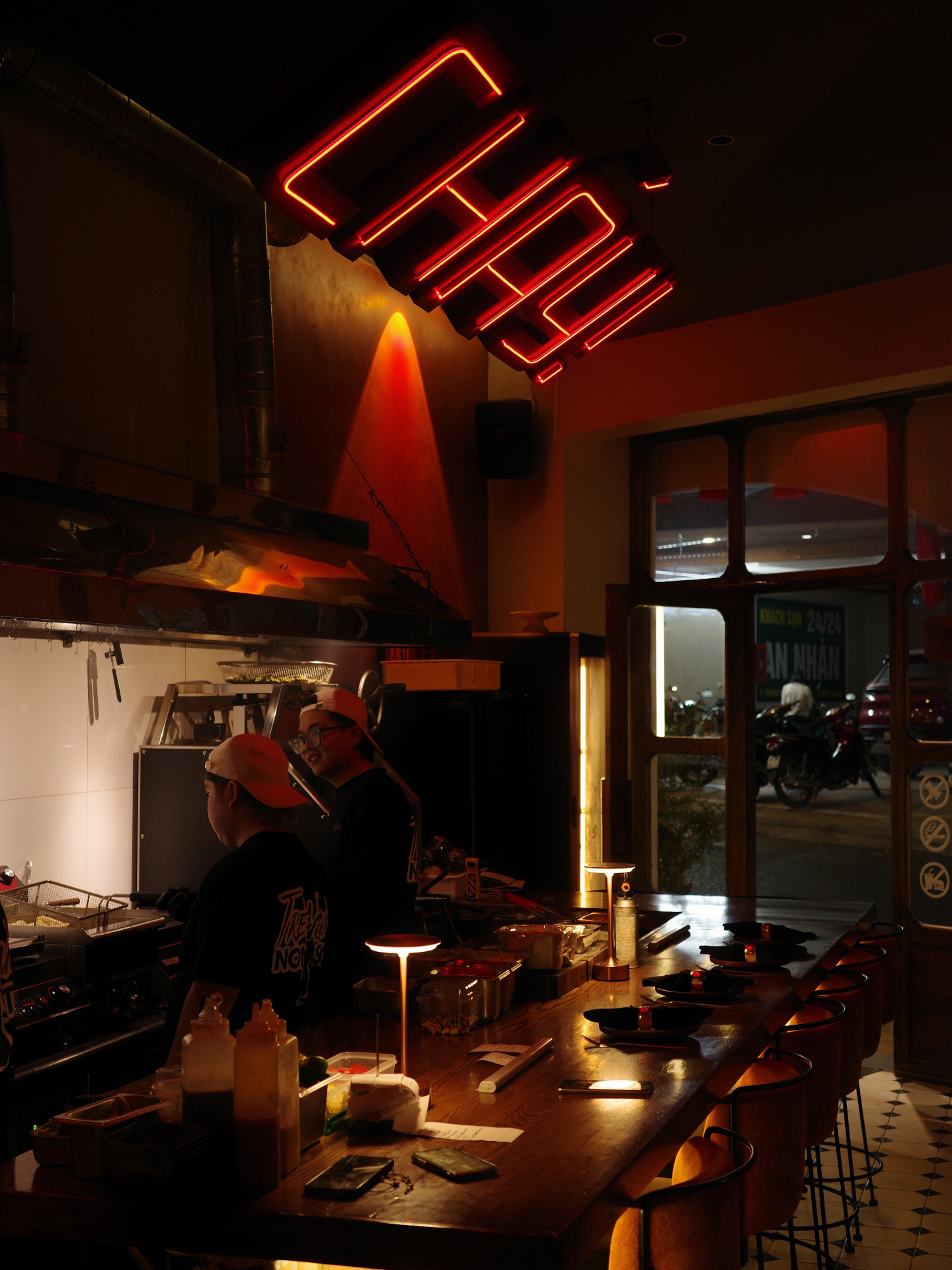 Cháy! neon sign and open kitchen